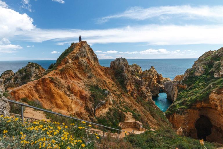 Man hiking on the seaside cliffs of Algarve, Portugal