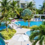 The Atrium Resort’s private swimming pools surrounded by palm trees and tropical gardens.
