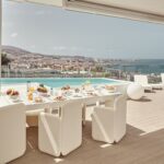 Baobab Suites BB Lounge Club dining table overlooking the pool and Costa Adeje coast