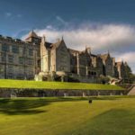 Bovey Castle exterior with expansive green and castle wall
