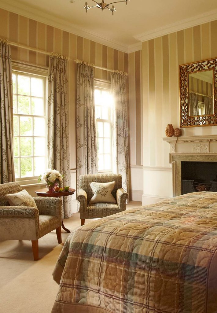 Feature Suite king bed and sitting area at Brockencote Hall