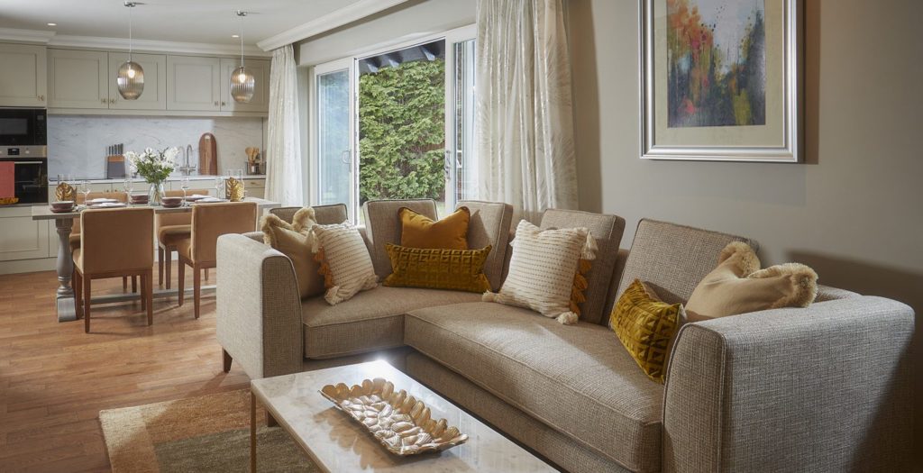 Open concept living room, dining area, and kitchen of the lodge at Brockencote Hall