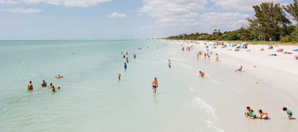View of people enjoying a day at the beach in Naples, Florida