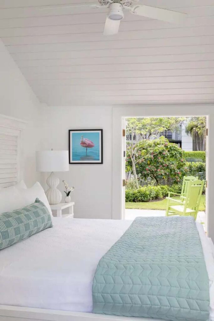 Coquina Cottage bedroom with queen bed and french doors leading to patio | The Capri Inn