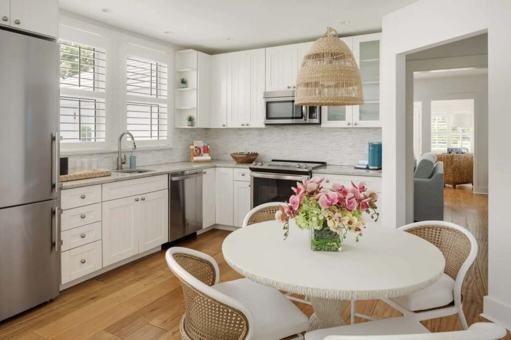 Coquina Cottage eat-in kitchen with stainless steel appliances and dining area | The Capri Inn