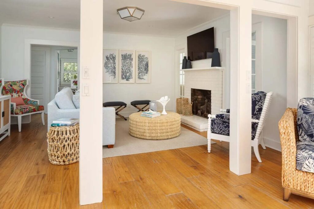 Coquina Cottage cozy living room with fireplace and mounted TV at the Capri Inn