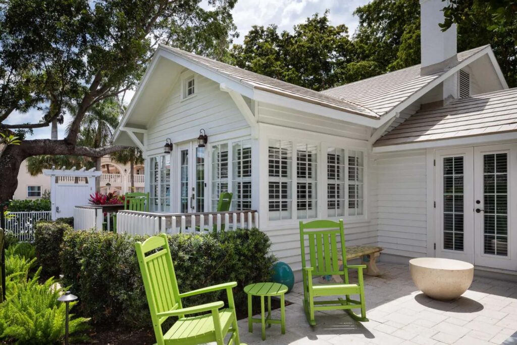 Coquina Cottage exterior patio with rocking chairs at the Capri Inn