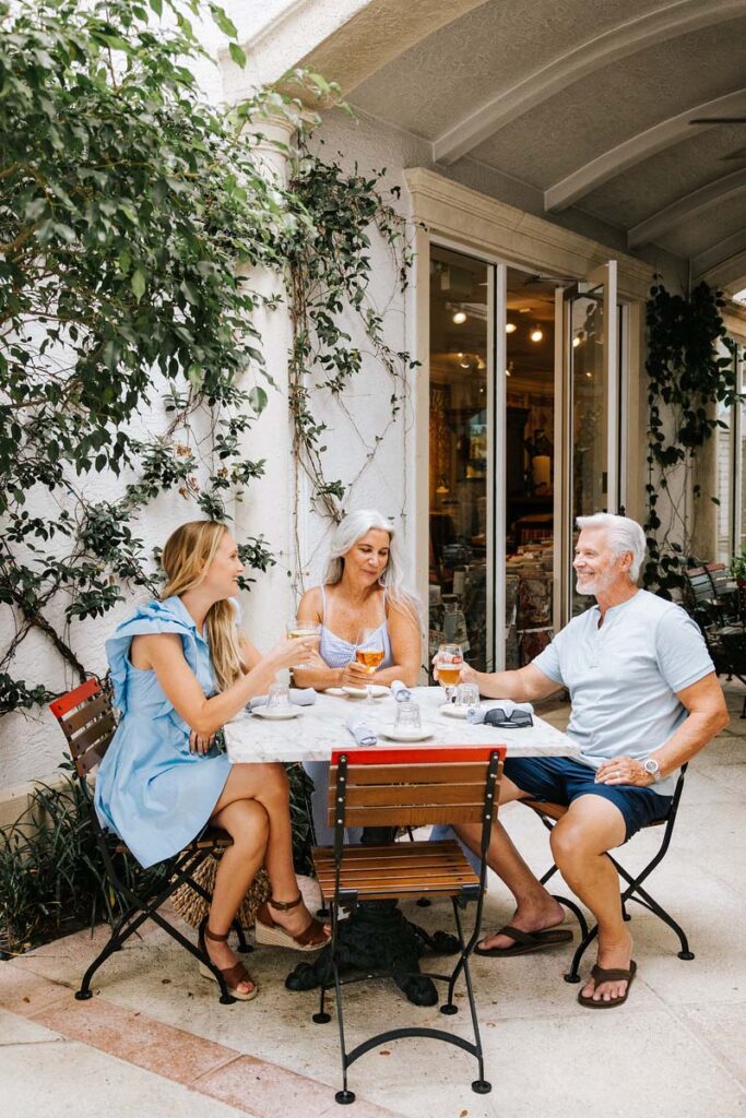 Family enjoying a sit-down meal outside a restaurant in Naples, Florida