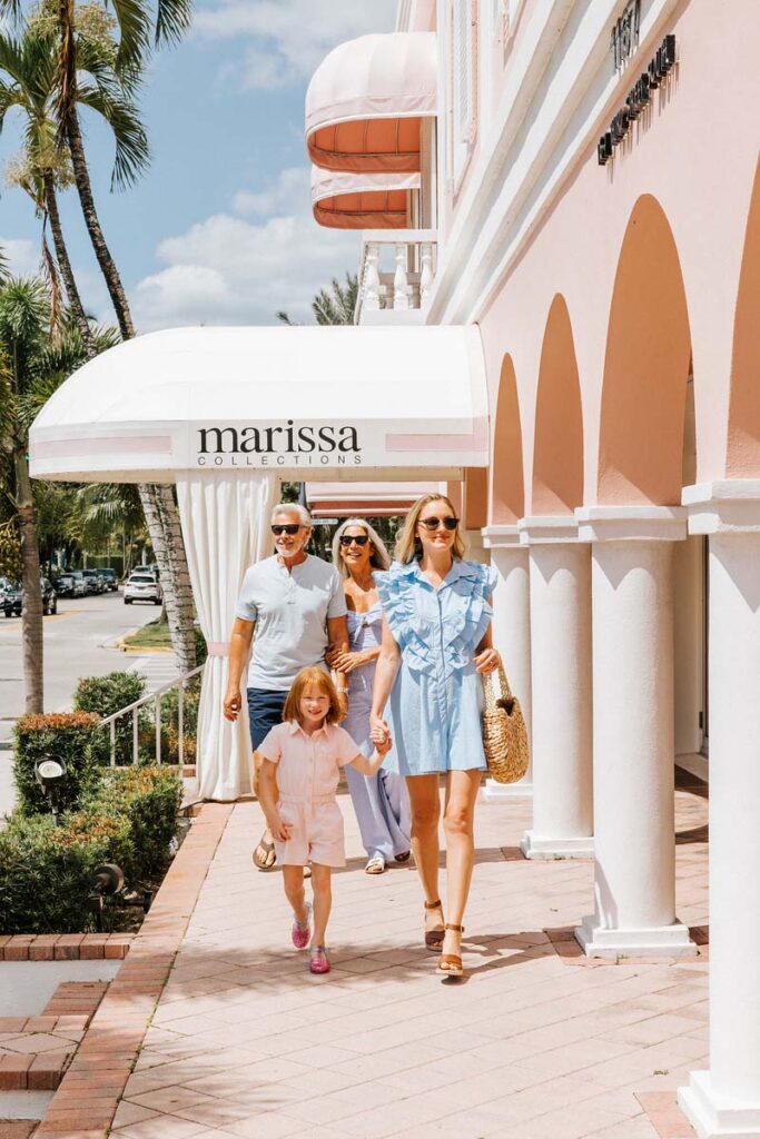 Family walking down a sidewalk in Naples, Florida