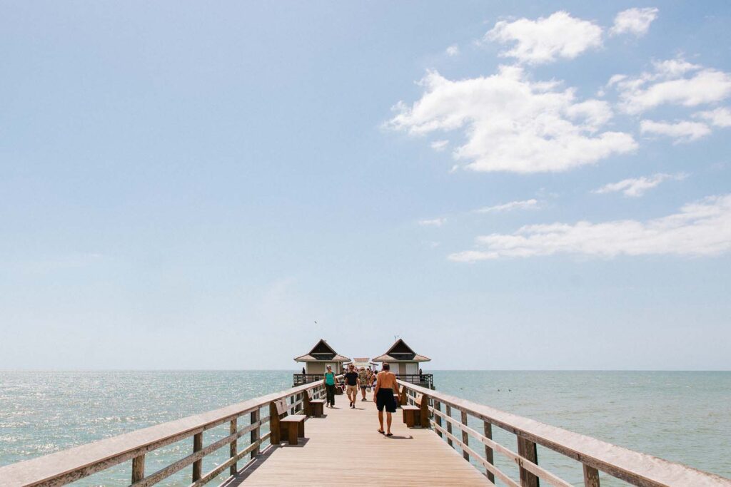 People walking on the Naples Pier