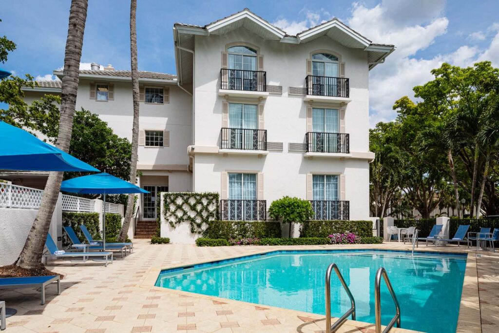 Outdoor pool surrounded by lounge chairs at the Capri Inn