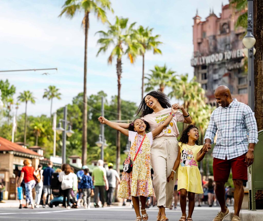 Happy family walking down Sunset Boulevard at Disney's Hollywood Studios