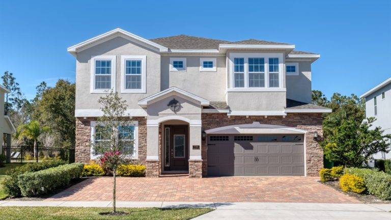 Front of an Encore Resort at Reunion residence with private driveway parking.