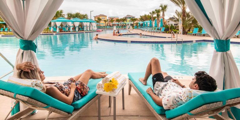 Couple relaxing under a private poolside cabana.
