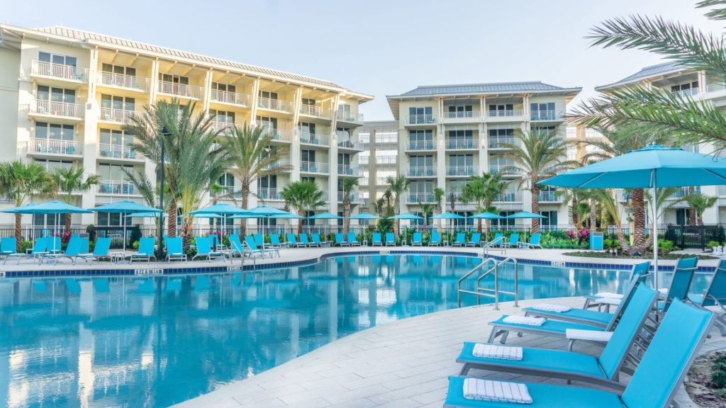 Lounge chairs set around the Fins Up Beach Club pool area of Margaritaville Resort Orlando