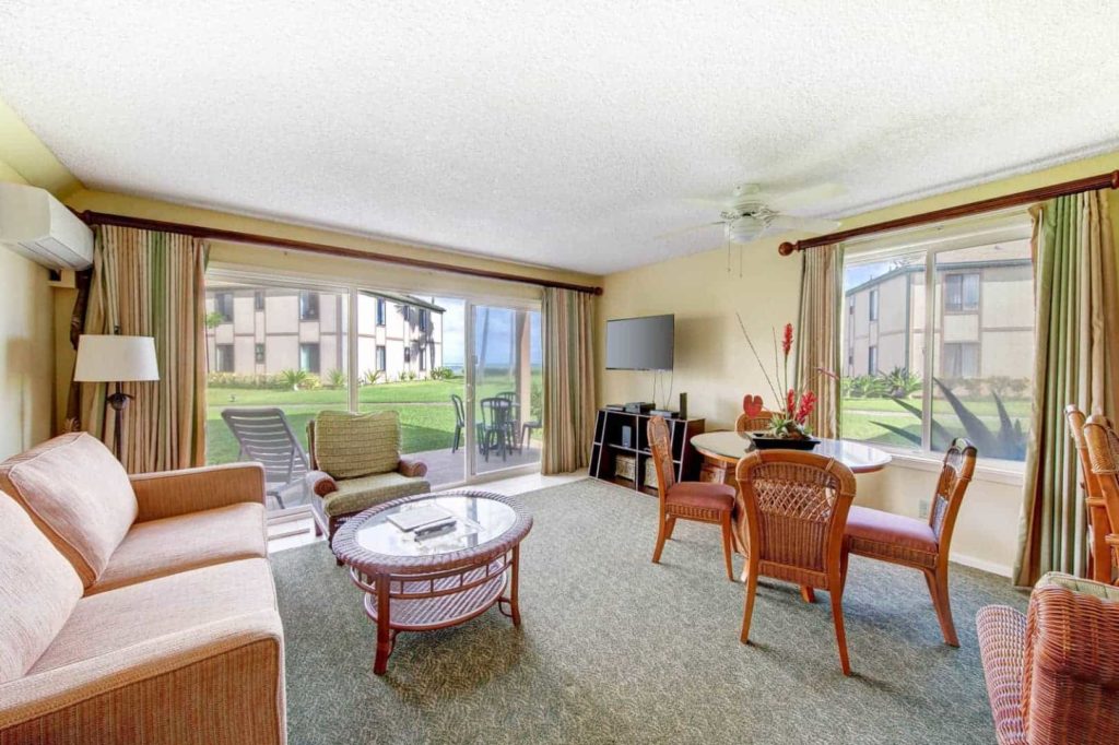 Living room with sliding door access to outdoor terrace in a Pono Kai Resort 2 Bedroom Unit