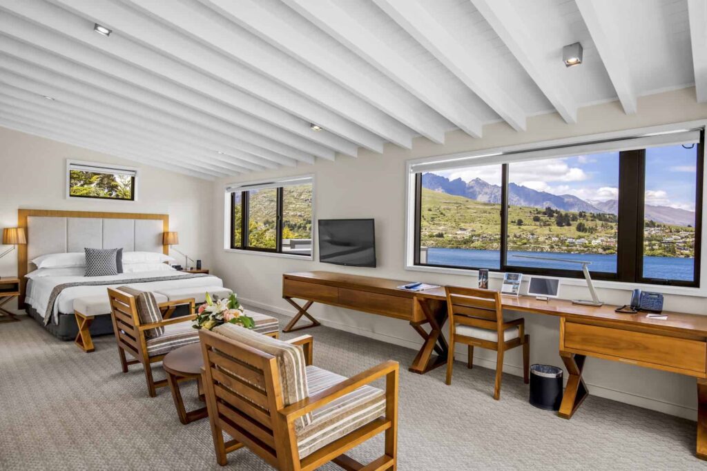 Executive Lake View Hotel Room with bed, armchairs, and large desk