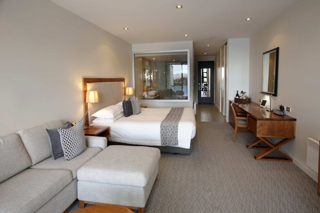 Executive Lake View Hotel Room with large king bed, desk, and sofa