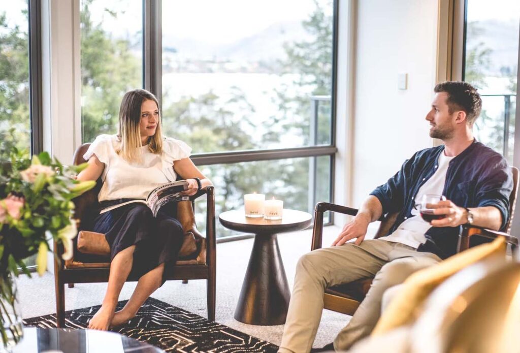 Couple sitting and relaxing at the Rees Hotel, New Zealand