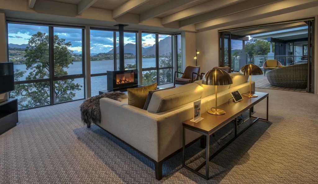 Living room with fireplace, TV, and large windows with lake view: Lake View 3 Bedroom Villa