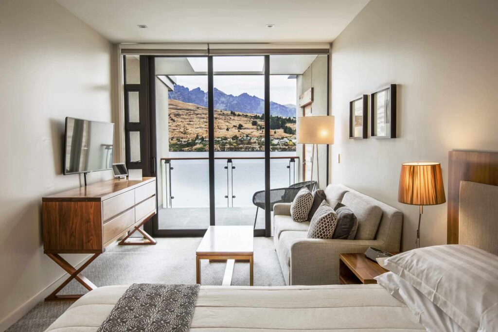 Lake View Hotel Room with sofa, TV, and king bed