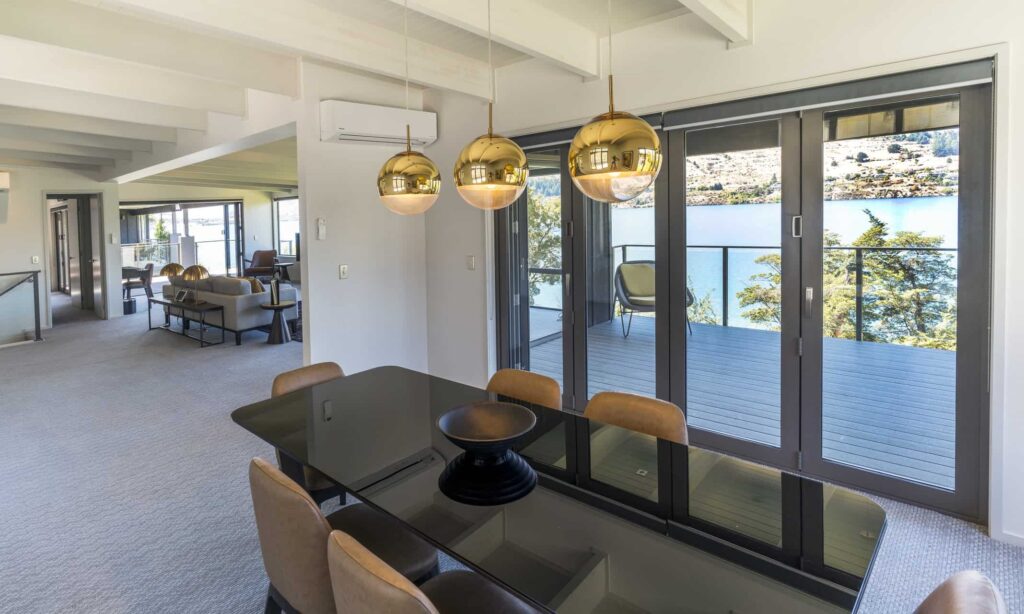 Rees Residence dining room with balcony access and lake view