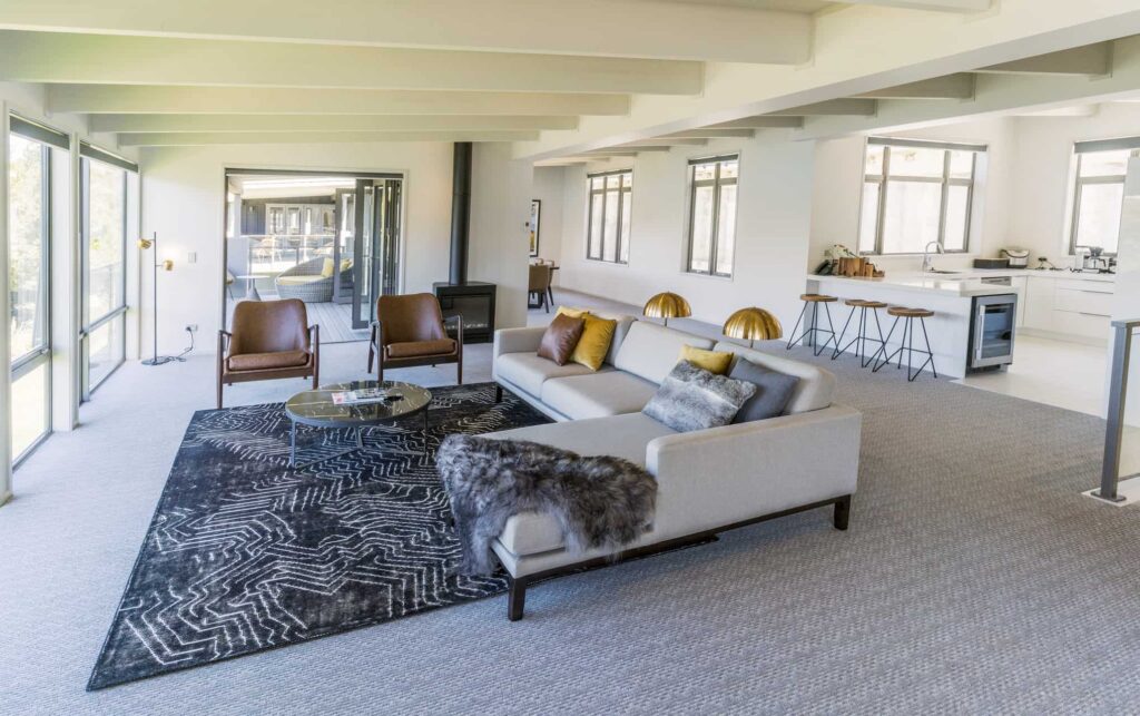 Rees Residence living room and kitchen area with sectional sofa and barstool seating