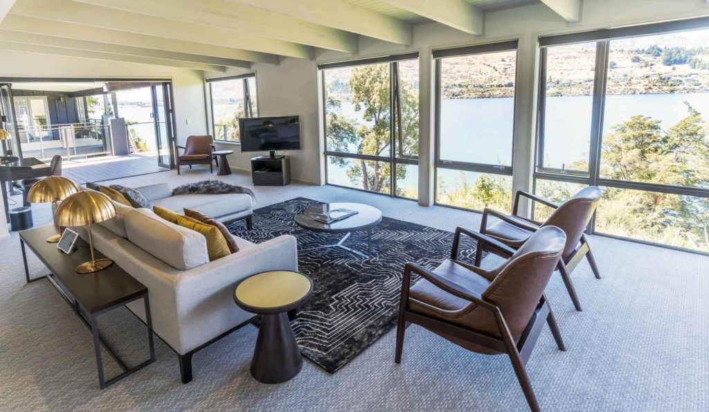 Rees Residence living room with lake view, TV, and sectional sofa