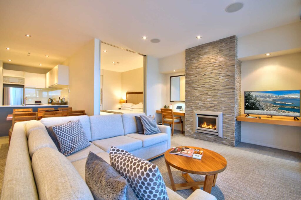 Superior Apartment living room with sectional sofa, TV, and fireplace