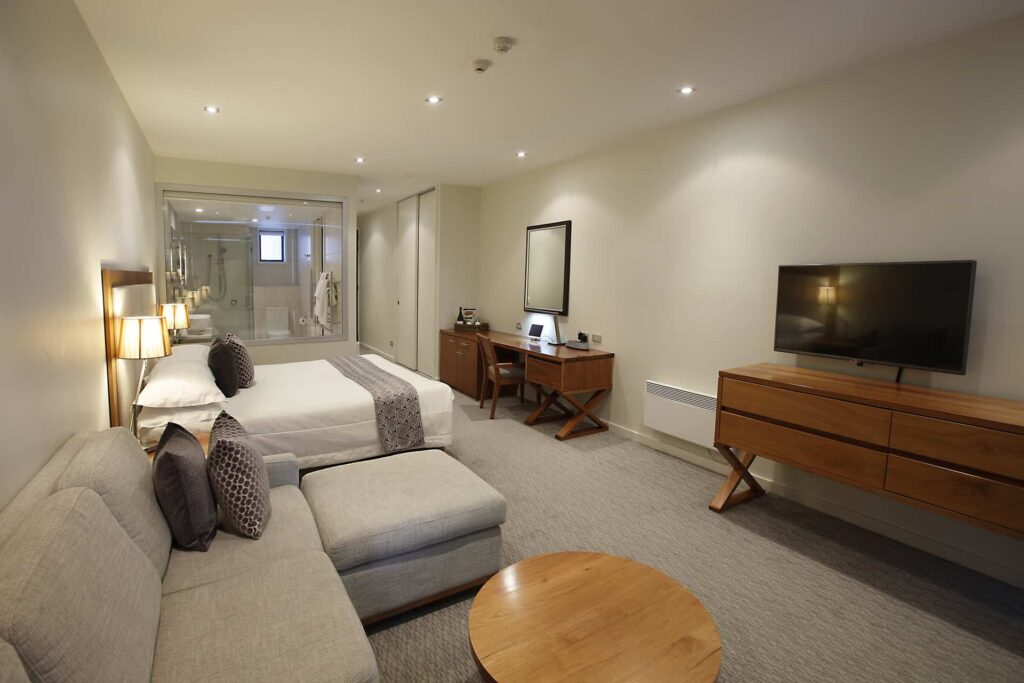 Superior Hotel Room with wall-mounted TV and sofa