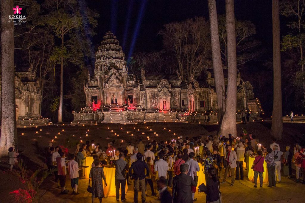 Large group of people attending a dinner outside of a historic temple near the Sokha Siem Reap Resort