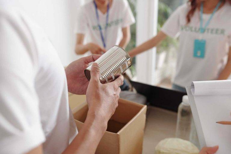 Volunteers packing canned goods into boxes